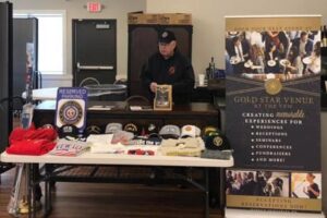 The Gold Star Venue at the VFW in Rochester, MN table displays banners and information about the venue and VFW Post 1215 during an indoor trade show.